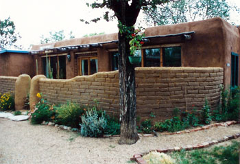 adobe home with exposed adobe privacy wall